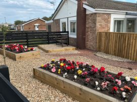 A garden with raised beds and flowers at North Sands in Beadnell