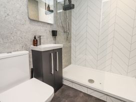 A bathroom with a toilet, sink, and shower at North Sands in Beadnell