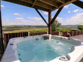 A hot tub with a scenic view at Llwyngwinau Isaf Barn in Tynreithyn near Tregaron