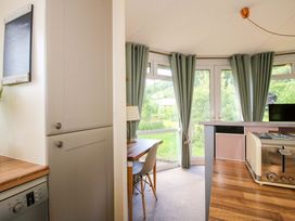 A kitchen with a table and chairs near a window at Dunromin in Montgomery