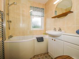 A bathroom with a bathtub, shower, and sink at Dunromin in Montgomery