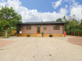 A house with a driveway and plants at Dunromin Montgomery