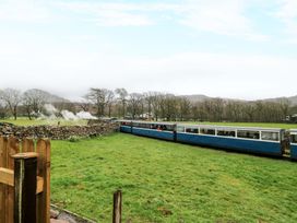 A steam train passing through a countryside area at Dakota in Boot