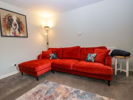 A living room with a red sofa and lamp at Dakota in Boot