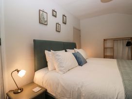 A bedroom with a bed and wall decor at Dakota in Boot