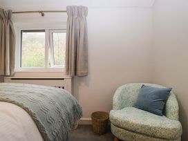 A bedroom with a window and a chair at Dakota in Boot