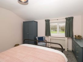 A bedroom with a bed and wardrobe at Dakota in Boot