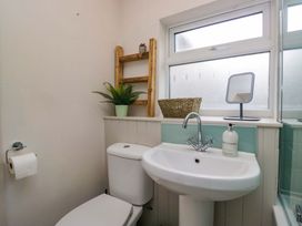 A bathroom with a toilet and sink at Dakota in Boot