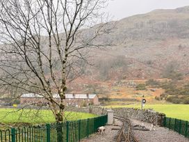 An outdoor view with a tree, railway tracks, and a house at Dakota near Boot