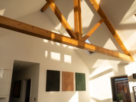 A room with exposed wooden ceiling beams and three rectangular wall art pieces at The Green Monkey in North Hykeham