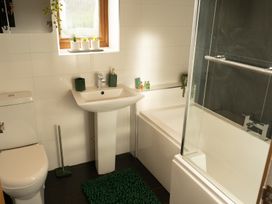 A bathroom with toilet sink bathtub and plants on the window sill at The Green Monkey in North Hykeham
