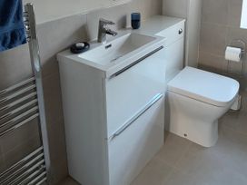 A bathroom with sink and toilet at Hen Stabl at Tyn Llan Llanbadrig Cemaes