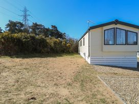 A mobile home with gravel area and bushes under clear sky at 31B Foxburrow Hang in Fritton near Belton Norfolk