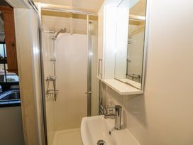 A bathroom with a shower enclosure sink and mirror cabinet at Perch Hut Hadlow Down near Crowborough