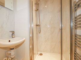 A bathroom with a sink and a glass enclosed shower at Trelowth Chapel in Polgooth
