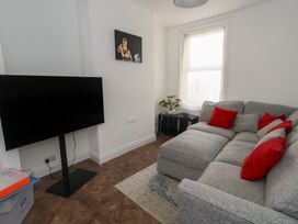 A living room with a sofa and television at Weymouth Seaside House in Weymouth