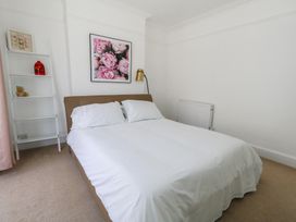 A bedroom with a bed and shelf at Weymouth Seaside House in Weymouth