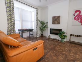 A living room with a foosball table and a plant at Weymouth Seaside House in Weymouth