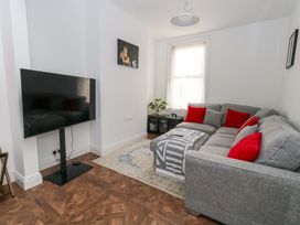 A living room with a sofa and television at Weymouth Seaside House in Weymouth