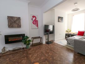 A living room with a couch and a television at Weymouth Seaside House in Weymouth