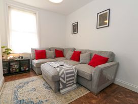 A living room with a sofa and cushions at Weymouth Seaside House in Weymouth