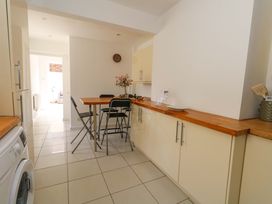 A kitchen with a table and chairs at Weymouth Seaside House in Weymouth