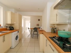 A kitchen with appliances and a table at Weymouth Seaside House in Weymouth