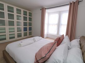 A bedroom with a bed and wardrobe at Weymouth Seaside House in Weymouth