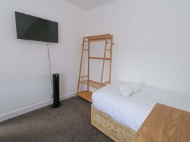 A bedroom with a bed and a television at Weymouth Seaside House in Weymouth