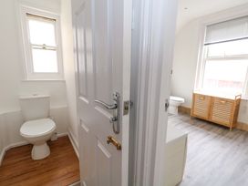 A bathroom with a toilet and cabinet at Weymouth Seaside House in Weymouth