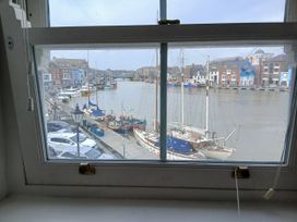 A view of boats and a canal from a window at Harbourside in Weymouth