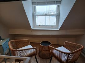 A snug area with two chairs and a table at Harbourside in Weymouth