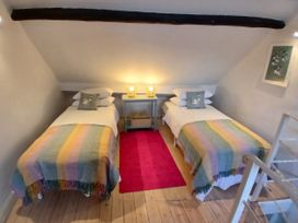 A bedroom with two beds and a nightstand at Harbourside in Weymouth