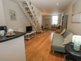A living room with a staircase and a sofa at Harbourside in Weymouth
