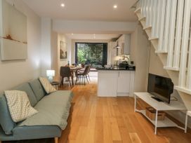 A living room with a sofa and television at Harbourside in Weymouth