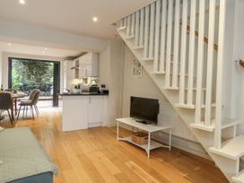 A living room with a sofa and television at Harbourside in Weymouth