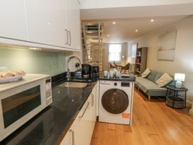 A kitchen with a washing machine and a microwave at Harbourside in Weymouth