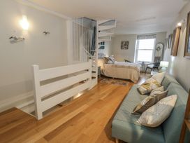 A bedroom with a spiral staircase and a bed at Harbourside, Weymouth