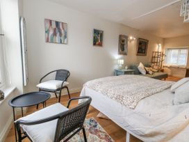 A bedroom with a bed and chair at Harbourside in Weymouth