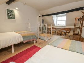 A bedroom with two beds and seating area at Harbourside in Weymouth