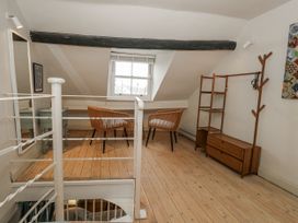 An attic with a table and two armchairs at Harbourside in Weymouth