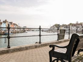A view of the harbor with boats and buildings at Harbourside in Weymouth