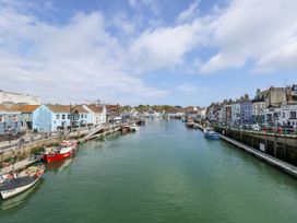 A marina with boats and buildings at Harbourside in Weymouth