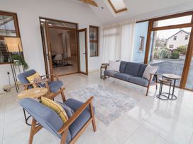 A living room with furniture and large windows at Ard Na Mara Drung near Quigley's Point County Donegal