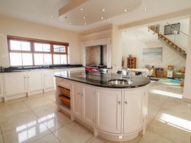 A kitchen with a central island and a stove at Ard Na Mara Drung near Quigley's Point County Donegal