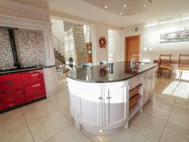 A kitchen with a red stove and island in Ard Na Mara Drung near Quigley's Point, County Donegal