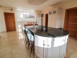 A kitchen with an island and stools at Ard Na Mara, Drung near Quigley's Point, County Donegal