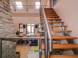 Stairs leading to upper floor with dining area visible at Ard Na Mara Drung near Quigley's Point County Donegal