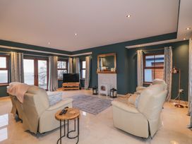 A living room with a television and a sofa at Ard Na Mara in Drung near Quigley's Point, County Donegal