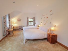 A bedroom with two beds and a bookshelf at Ard Na Mara in Drung near Quigley's Point, County Donegal